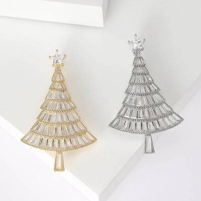 Grouped view of baguette crystal Christmas tree brooch with graduated branches arranged together.