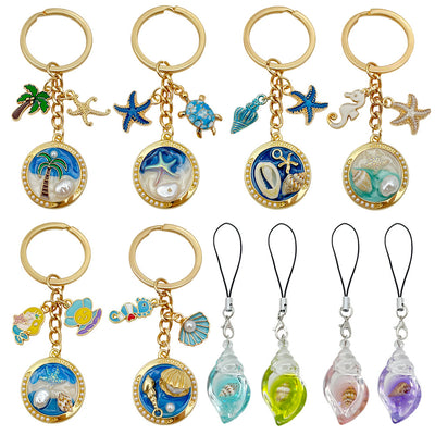 Overview showing the available color and design variations of the ocean scene metal keychains and resin shell phone stra