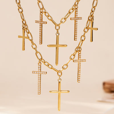 Gold multi-cross layered pendant necklace flat lay on white