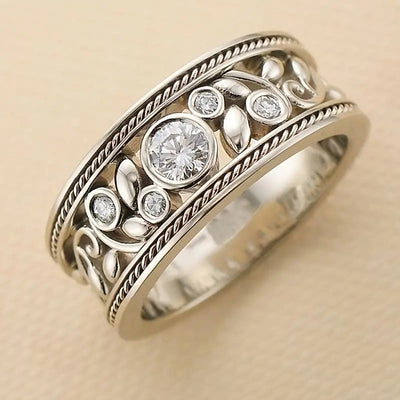 Product view showing wide antiqued silver-tone ornate bezel clear-stone ring