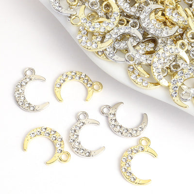 Assorted moon charms arranged on a white surface