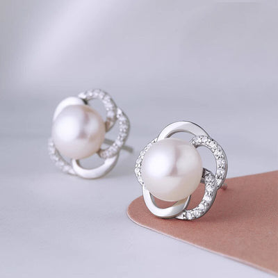 Front pair shot of silver pearl open flower stud earrings