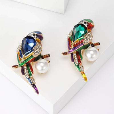 Front view of colorful bird brooch with crystal body and pearl dangle
