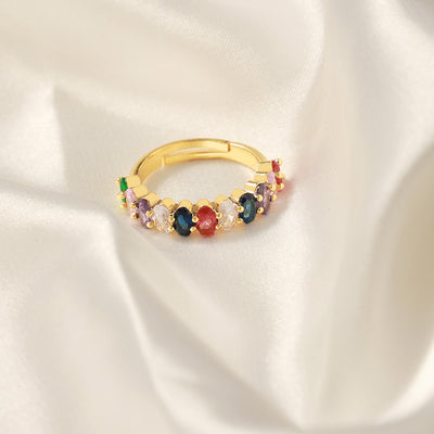 Gold open ring with multicolor oval zircon stones on white silk