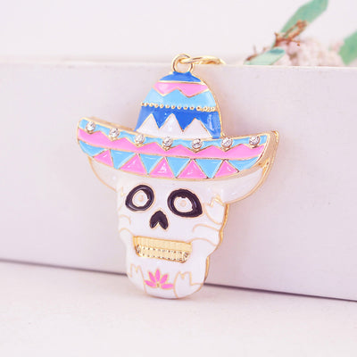 Angled front view of a white skull charm wearing a pink and blue sombrero with clear stones.
