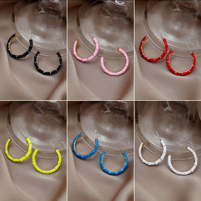 Six-color bamboo segment C-hoop stud earrings collage on fabric