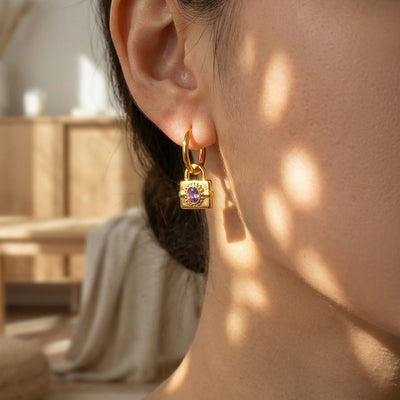 On-ear view of oval stone lock drop hoop earrings in main image 1.