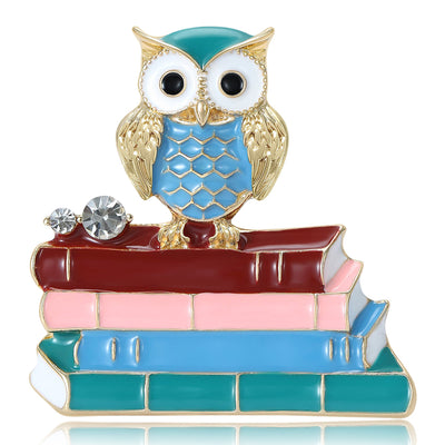 Front view of the crystal owl on colorful stacked books brooch decorative clothing pin on a white background
