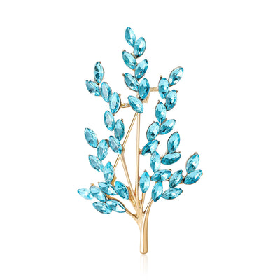 Navy Branch, Aqua Branch brooch styles arranged on a light display