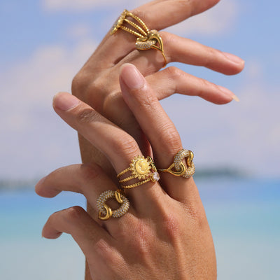 Gold sun cactus zircon open ring worn with other gold rings on hands