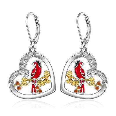 Silver tone heart bird drop earrings with red enamel details, detail view highlighting the setting and finish