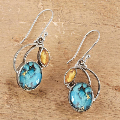 Pair of silver turquoise oval amber marquise hook earrings on wood board