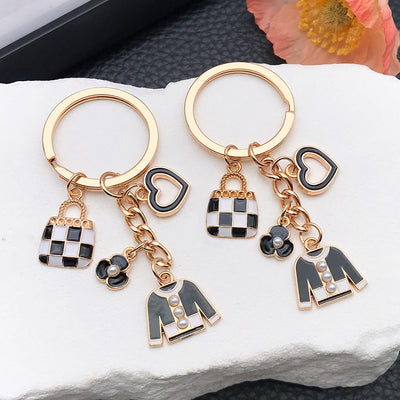 Overview showing the available color and design variations of the black white handbag heart and jacket metal keychain