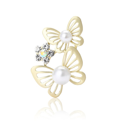 Matte gold twin butterfly pearl brooch front on white