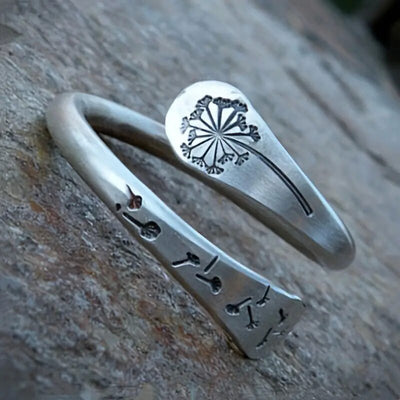 Antique silver open dandelion ring close-up on stone showing seed-head engraving