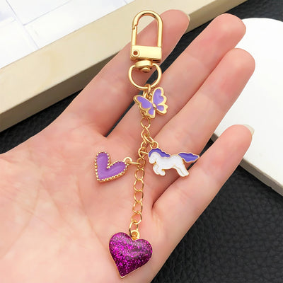 Overview showing the available color and design variations of the purple heart butterfly and carousel metal clasp keycha