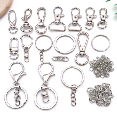 Metallic carabiner clasp jewelry findings arranged on a light background
