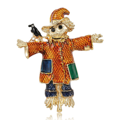 Orange Scarecrow brooch styles arranged on a light display
