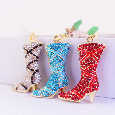 Three rhinestone boot charms in white, blue and red stand side by side.