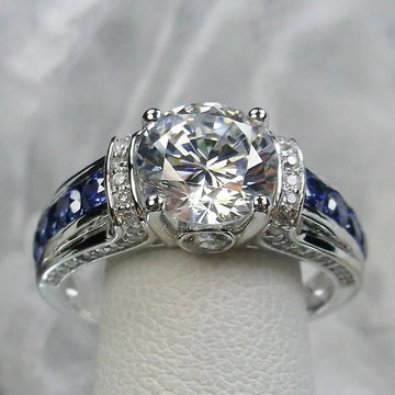 Round Clear Solitaire Blue Channel-Side Ring Silver Tone