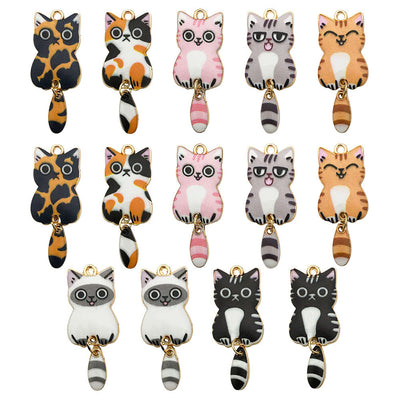 Metallic cat charms arranged on a light background