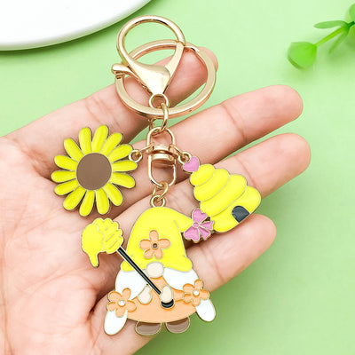 Image 1 showing a person holding a keychain with some flowers.
