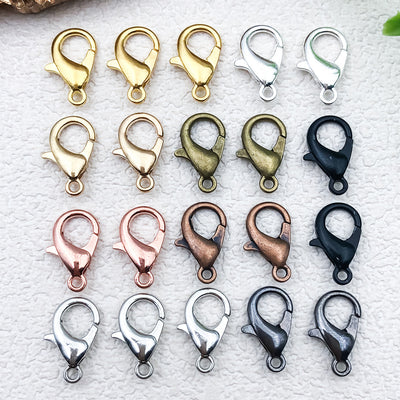 Metallic lobster clasp jewelry findings arranged on a light background