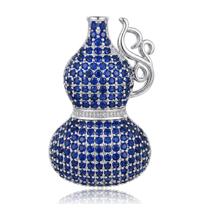 Front product view of the gourd covered in blue crystals with a polished silver-tone swirl handle brooch
