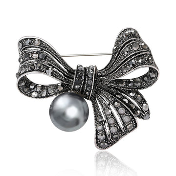 Black Bow Pearl Brooch With Faceted Crystals And Polished Metal Details