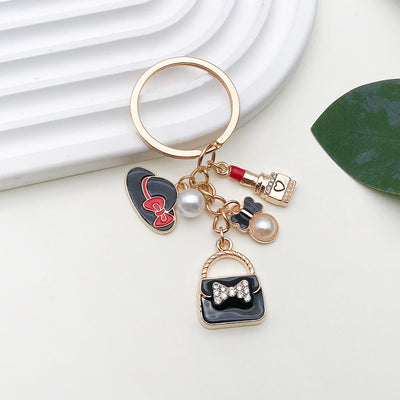 Main display of black handbag lipstick heel and pearl charm keychain