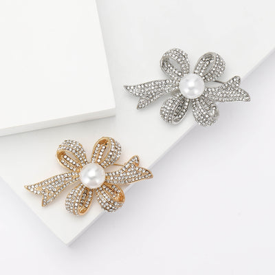 Product image 1 showing the layered crystal ribbon bow brooch with faux pearl center.