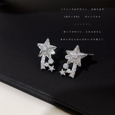 Silver pavé shooting star studs on black fabric with text overlay