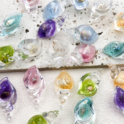 Colorful seashell charms arranged on a light background