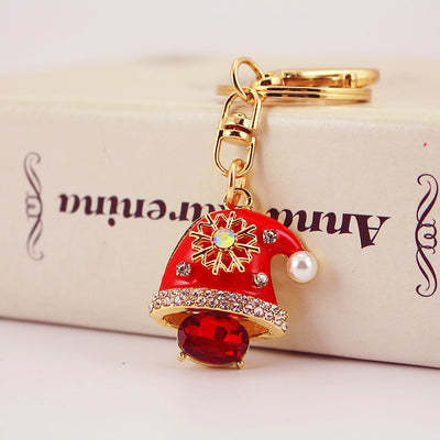 Close-up front view of a red Santa hat keychain with rhinestones and a gold-tone key ring.
