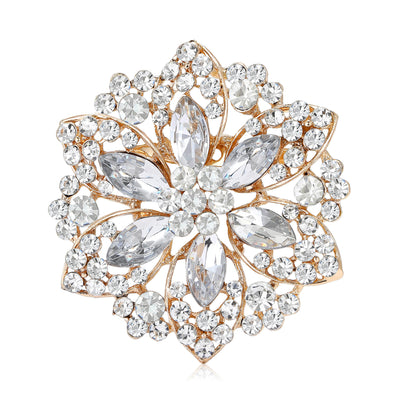 Front view of gold crystal flower brooch against a white background.