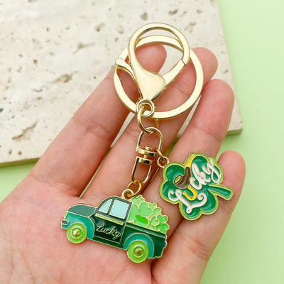 Image 1 showing a person holding two key chains in their hand.
