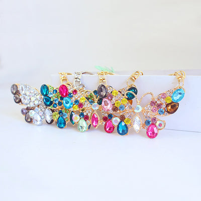 A row of faceted-stone butterfly keychains in assorted colors.