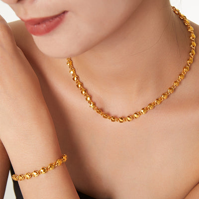 Gold hollow heart link necklace and bracelet worn on model