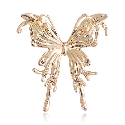 Gold polished butterfly brooch front on white