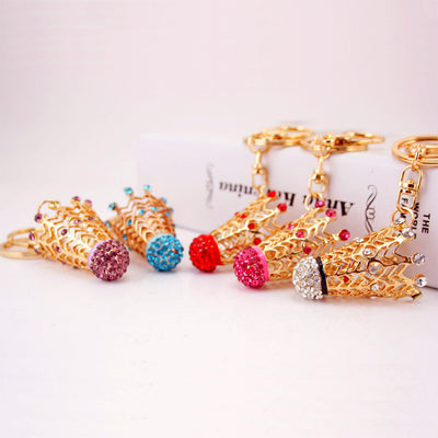 Five gold-tone shuttlecock keychains with red, pink, blue, purple, and clear rhinestone accents.