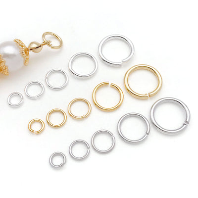 Front overview of closed metal jump rings in five sizes arranged by finish and size