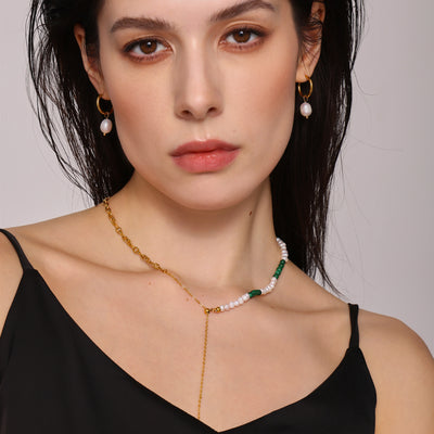 Model wears pearl turquoise Y necklace and pearl hoop earrings