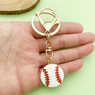 Image 1 showing a hand holding a baseball keychain.