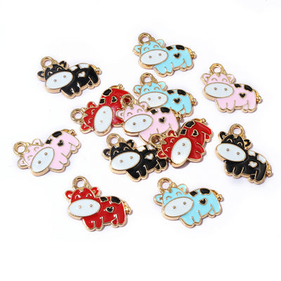 Enamel cow charms showing assorted shapes and finishes