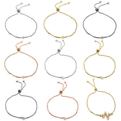 Metallic assorted shape charms arranged on a light background