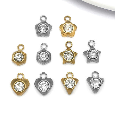 Metallic assorted shape charms arranged on a light background