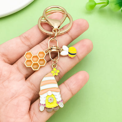 Image 1 showing a hand holding a keychain with some items.