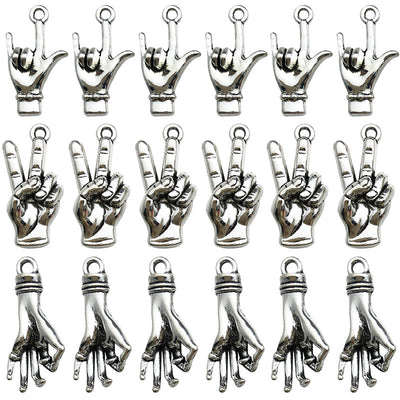 Antique silver assorted shape charms arranged on a light background