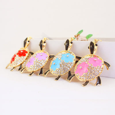 Four turtles with red, purple, blue, and pink flower accents displayed in a row.