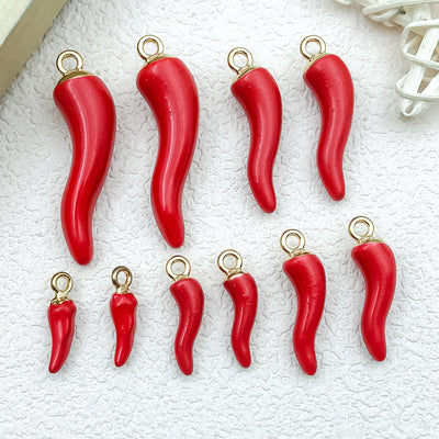 Colorful chili pepper charms arranged on a light background